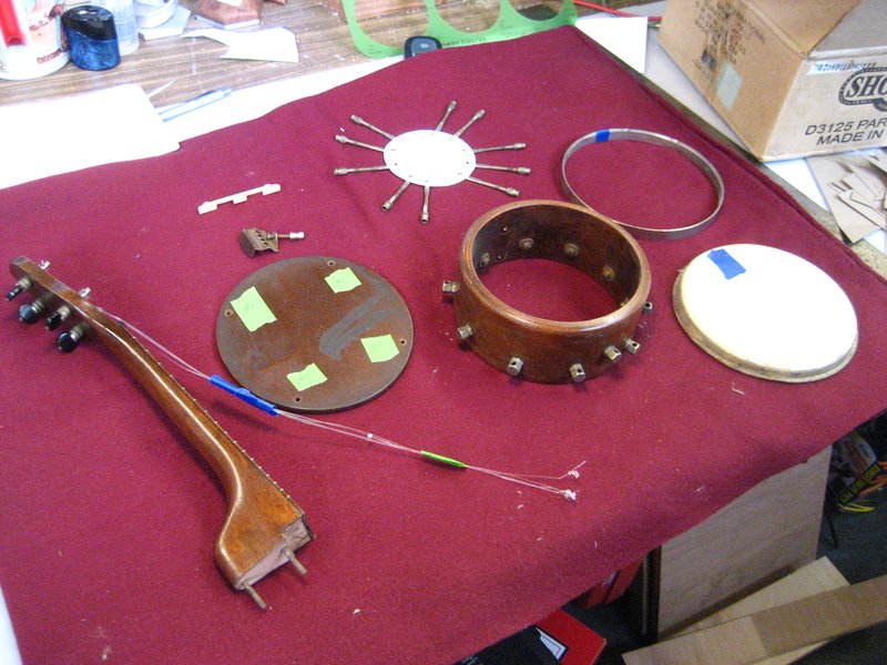 Disassembled 1925 Gibson UB-1 banjo ukulele on a workbench